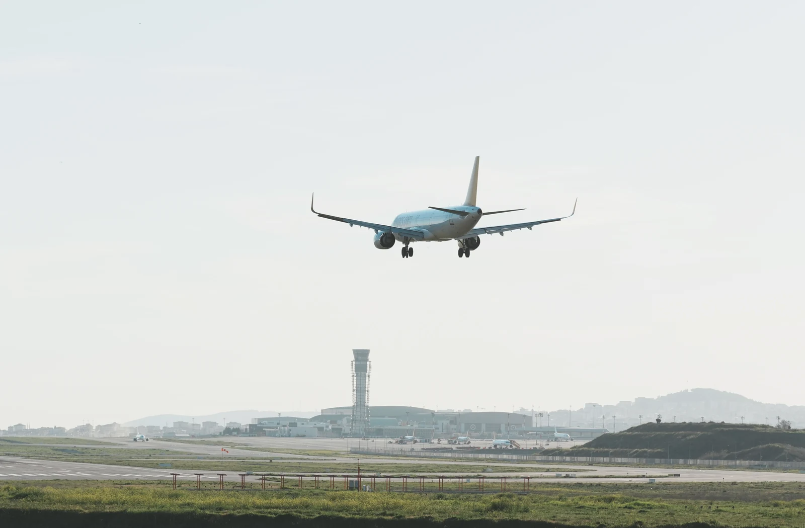 Commercial passenger airplane approaching an airport runway
